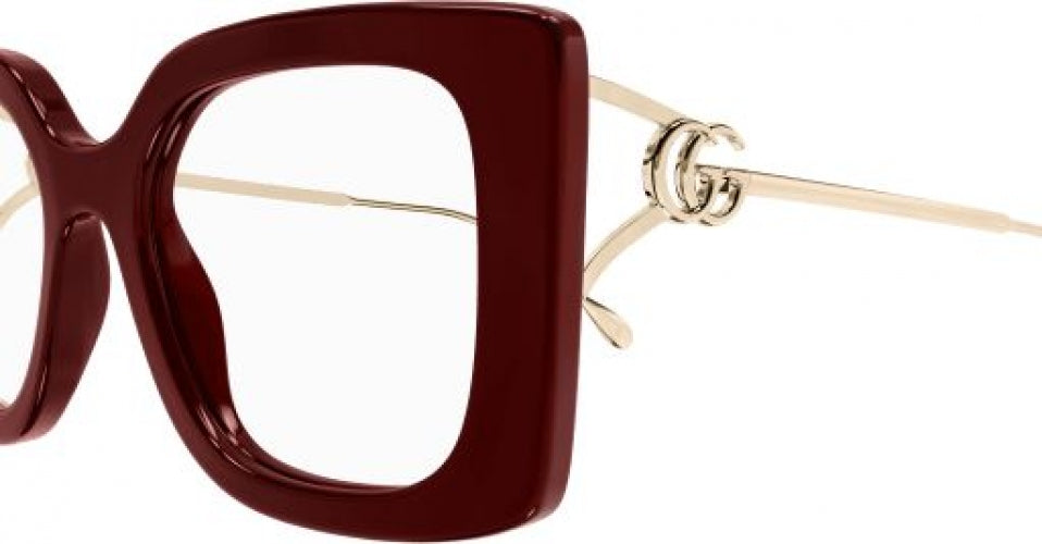 Burgundy square eyeglasses frame close-up with gold hinge and clear lens