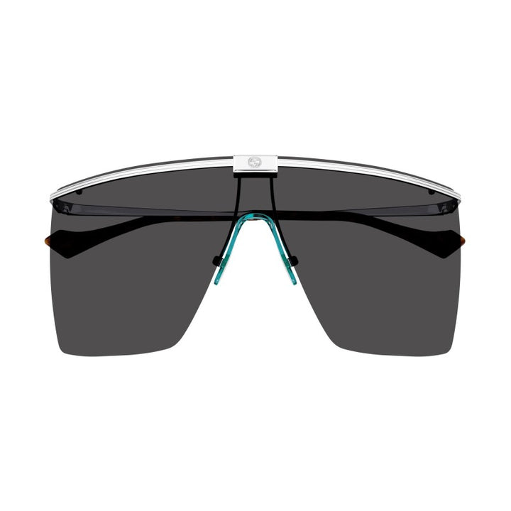 Rimless shielded sunglasses with dark lenses and turquoise bridge detail