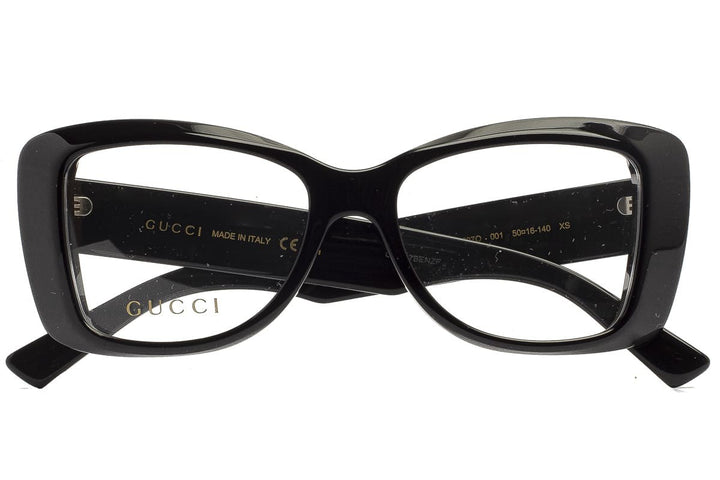 Black cat-eye eyeglass frames with Gucci logo on inner arms