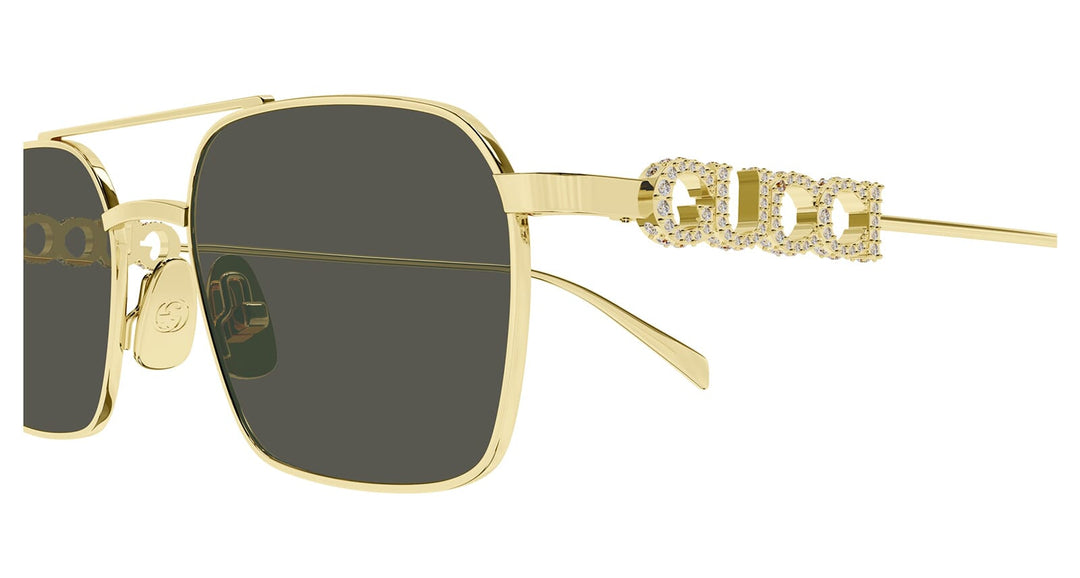 Gold metal sunglasses with dark lenses and crystal GG temple ornament