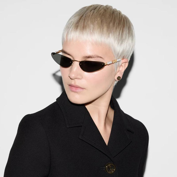 Gucci GG1257S Gafas de sol redondeadas con lentes marrones y rojos