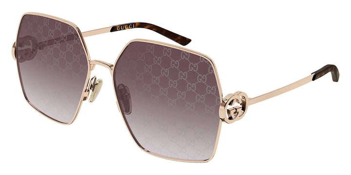 Oversized rose gold metal sunglasses with dark gradient lenses and logo-pattern frames