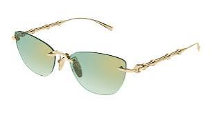 Cat-eye sunglasses side view with gold metal frame and green tinted lenses
