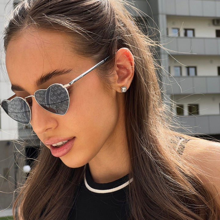 Heart-shaped sunglasses with silver-tone frames and dark gray gradient lenses