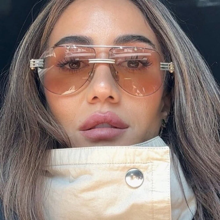 Aviator sunglasses with silver metal frame and amber tinted lenses