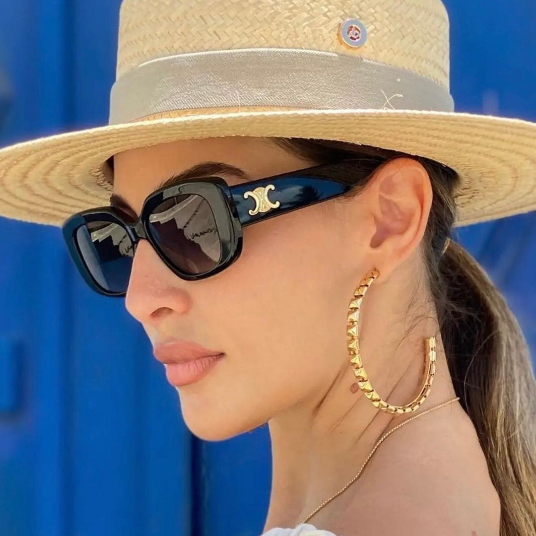 Celine sunglasses, dark lenses and burgundy frames, gold logo on temple, worn
