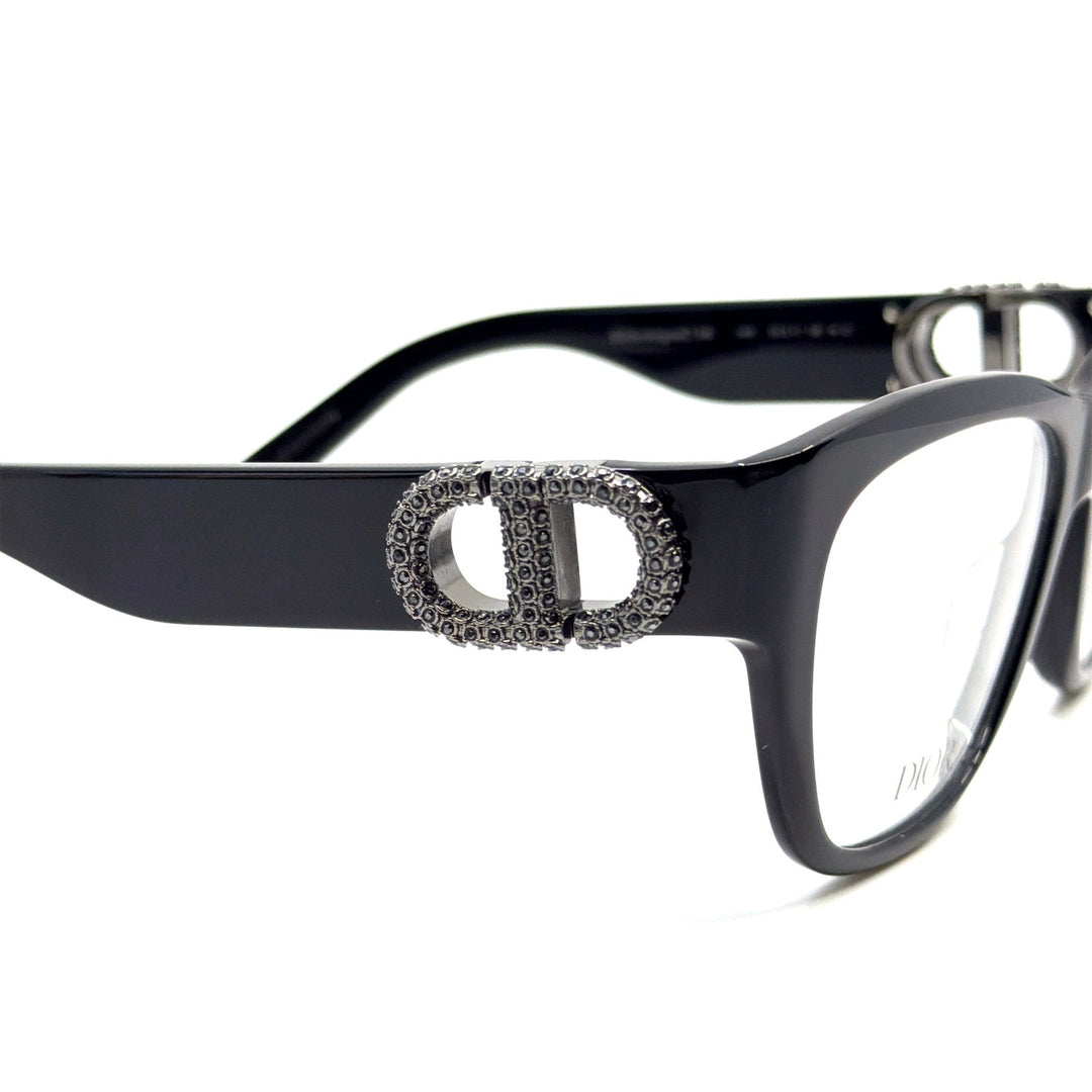 Black cat-eye eyeglass frames with large rhinestone Dior emblem detail