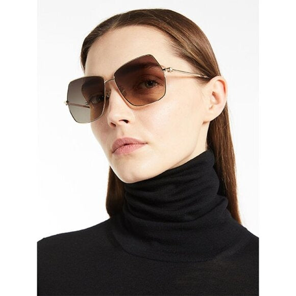 Gold sunglasses with brown gradient lenses and tortoise temple tips
