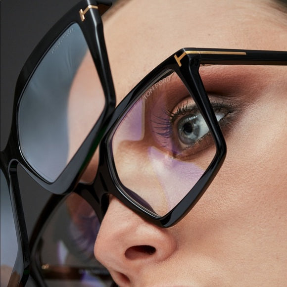 Tom Ford black clip-on sunglasses close-up, rectangular frame and temple hinge