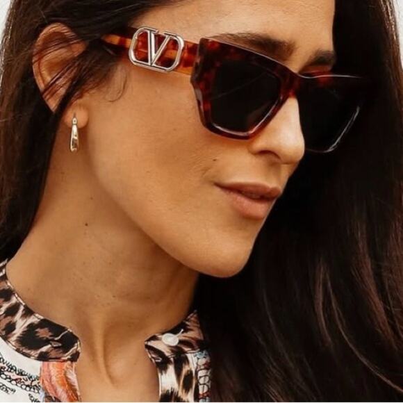 Valentino tortoise cat eye sunglasses on model, green lenses, V logo