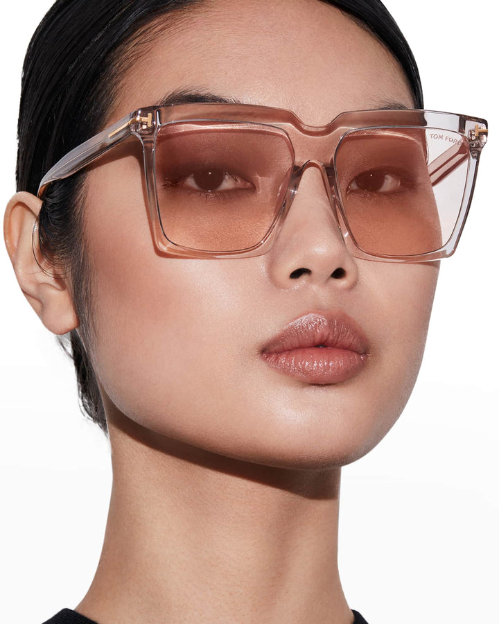Pink square sunglasses on face, brown gradient lenses and clear frame temples