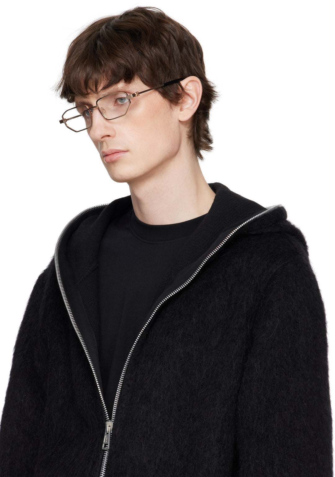 Gold metal eyeglasses on a person with off-white frame and dark temple tips