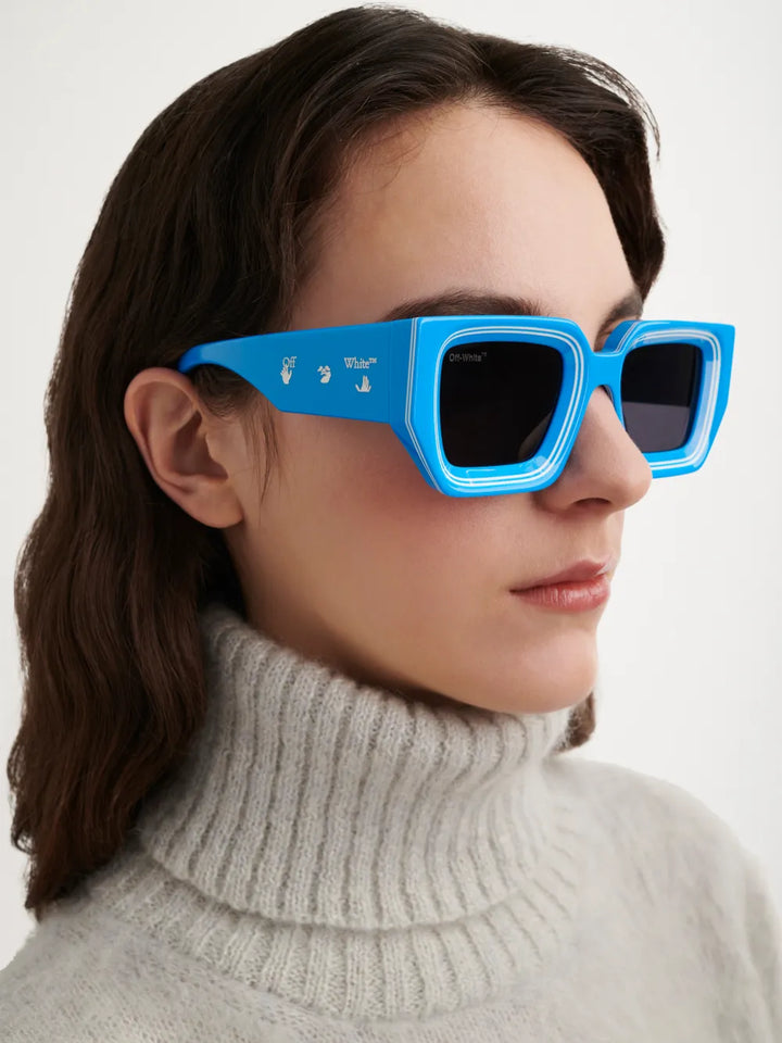 Blue Off-White Francisco sunglasses on face, square frames with dark lenses