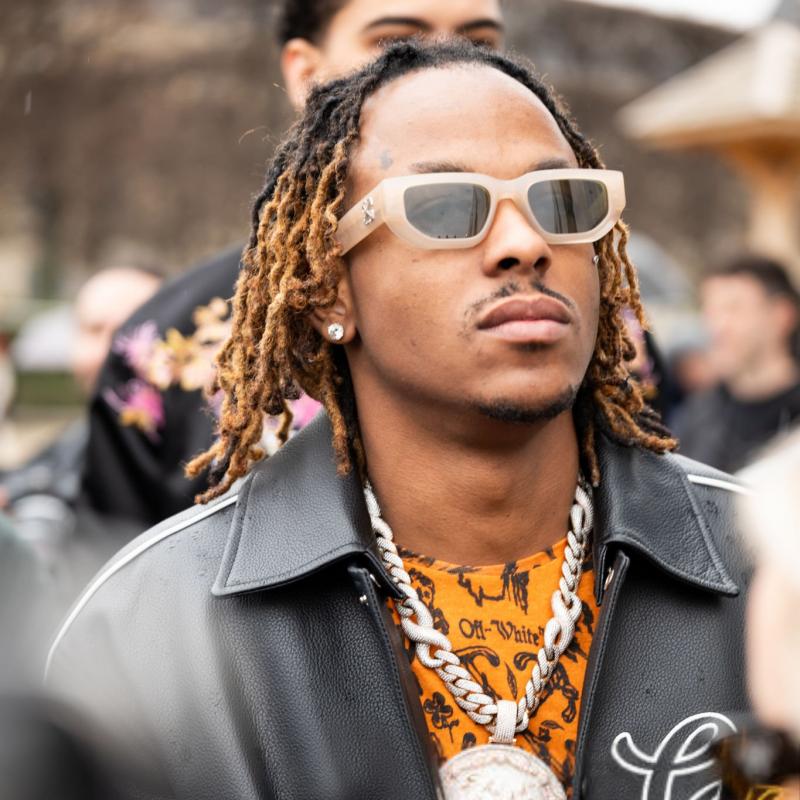 Off-White Greeley sunglasses on face, beige frame with dark green tinted lenses