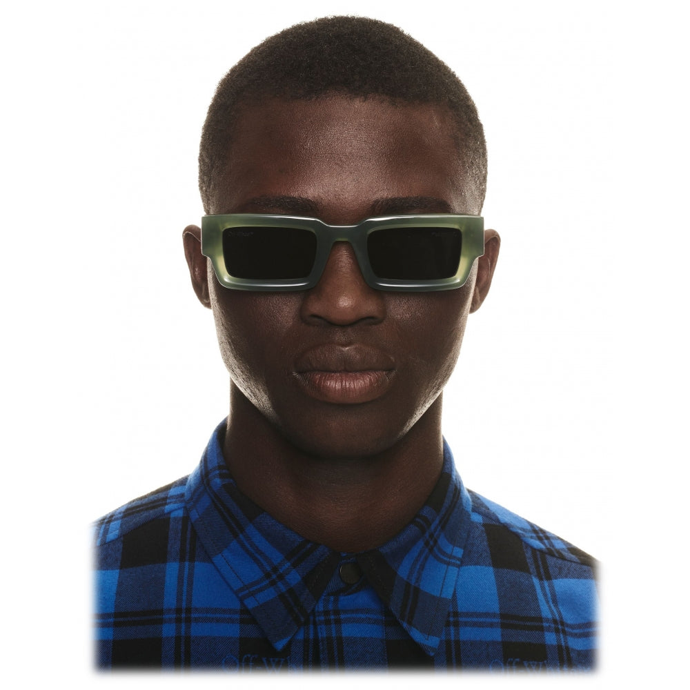 Off-White™ green sunglasses worn by model, dark tinted square lenses