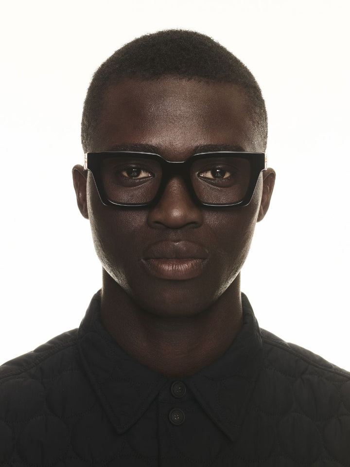 Black rectangular eyeglass frames worn front view, full-rim design