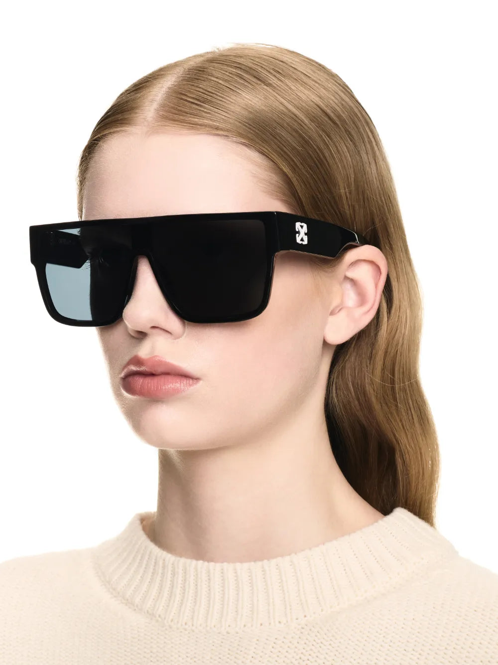 Black square sunglasses with dark lenses worn by a model