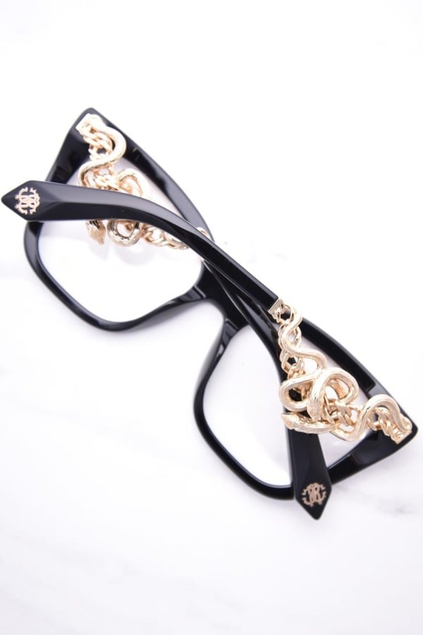 Black eyeglass frames with gold snake motif on temple ends and side
