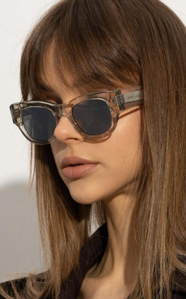 Saint Laurent SL573 clear mirror sunglasses on model with dark round frames