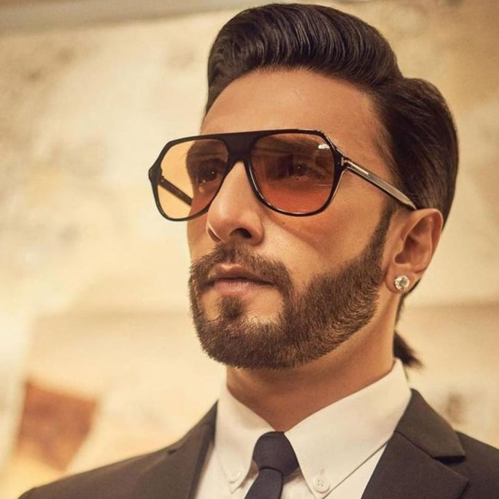 Tom Ford black aviator sunglasses on face with amber lenses
