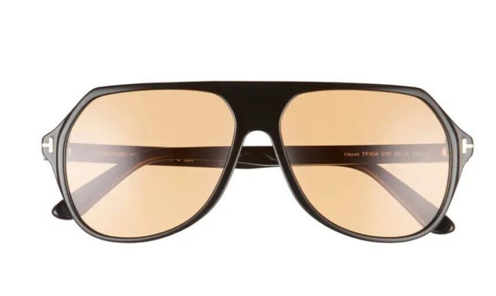 Black aviator sunglasses with amber lenses, Tom Ford logo on temple