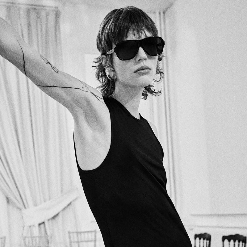 Saint Laurent SL609 black oversized sunglasses with dark lenses, worn on face
