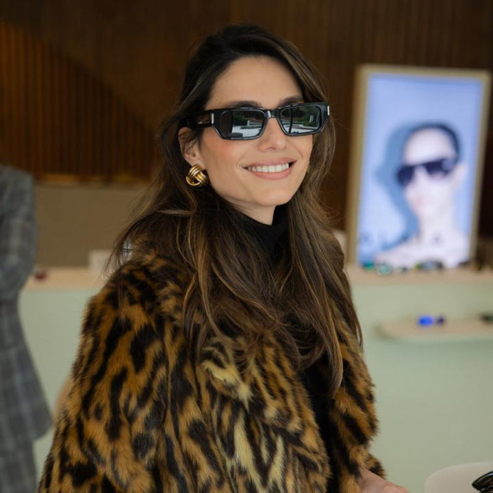 Saint Laurent SL660/F black sunglasses on a woman, dark rectangular lenses