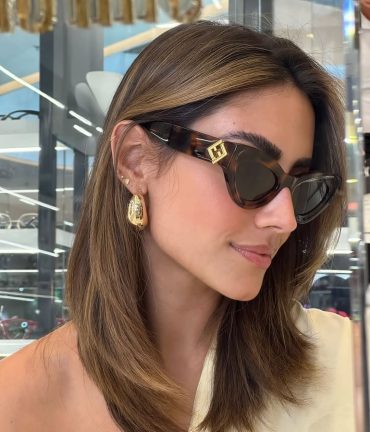 Havana brown cat-eye sunglasses with dark lenses, gold FF logo at temple, worn by model