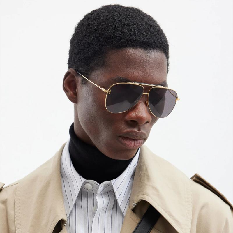 Aviator sunglasses side view with gold frame and dark gray tinted lenses