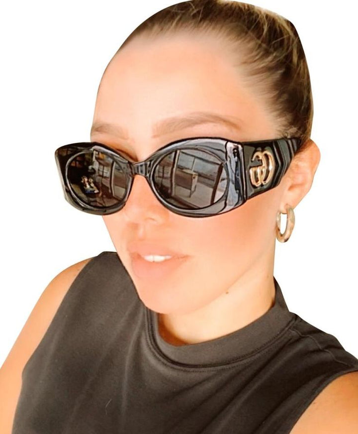Black rectangular sunglasses with GG emblem on side and dark reflective lenses.